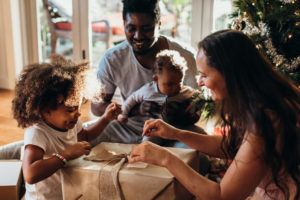 mom and dad playing with two sons for the holidays