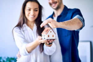 mom and dad couple holding and protecting their home