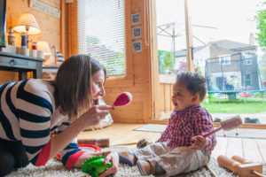 nanny playing with a baby