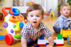 infant boys playing with toys