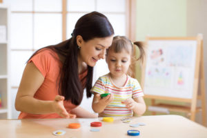 nanny teaching a child in a home