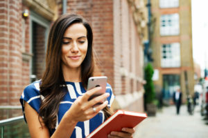 female personal assistant outside on phone