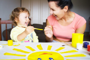 nanny painting with child