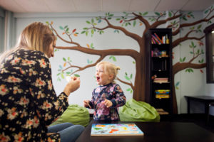 nanny playing with young child